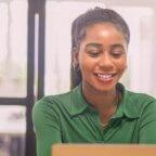 Female practice owner looking at computer for their practice growth checklist.