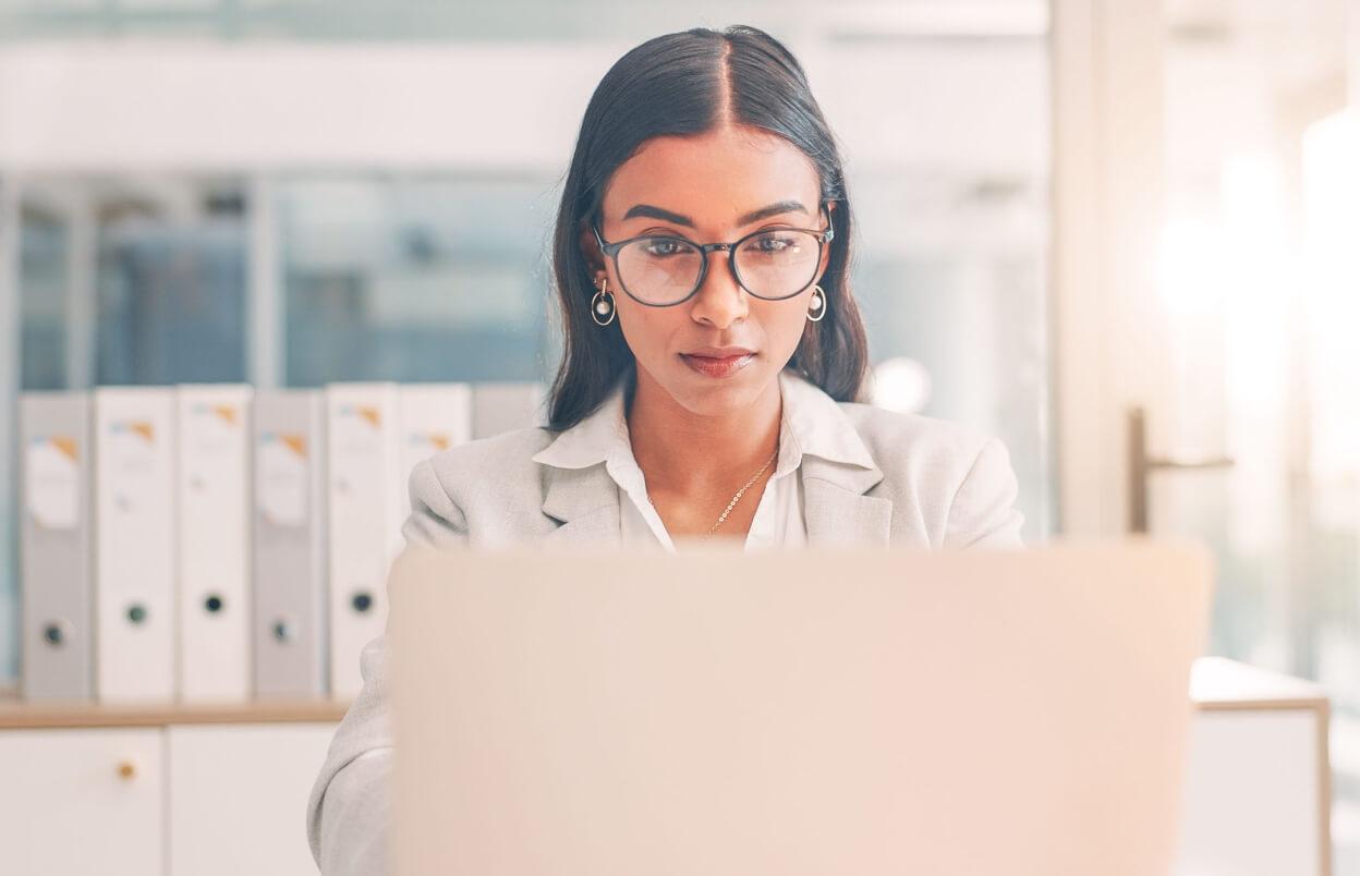 medical practice owner l looking at computer and managing online reputation