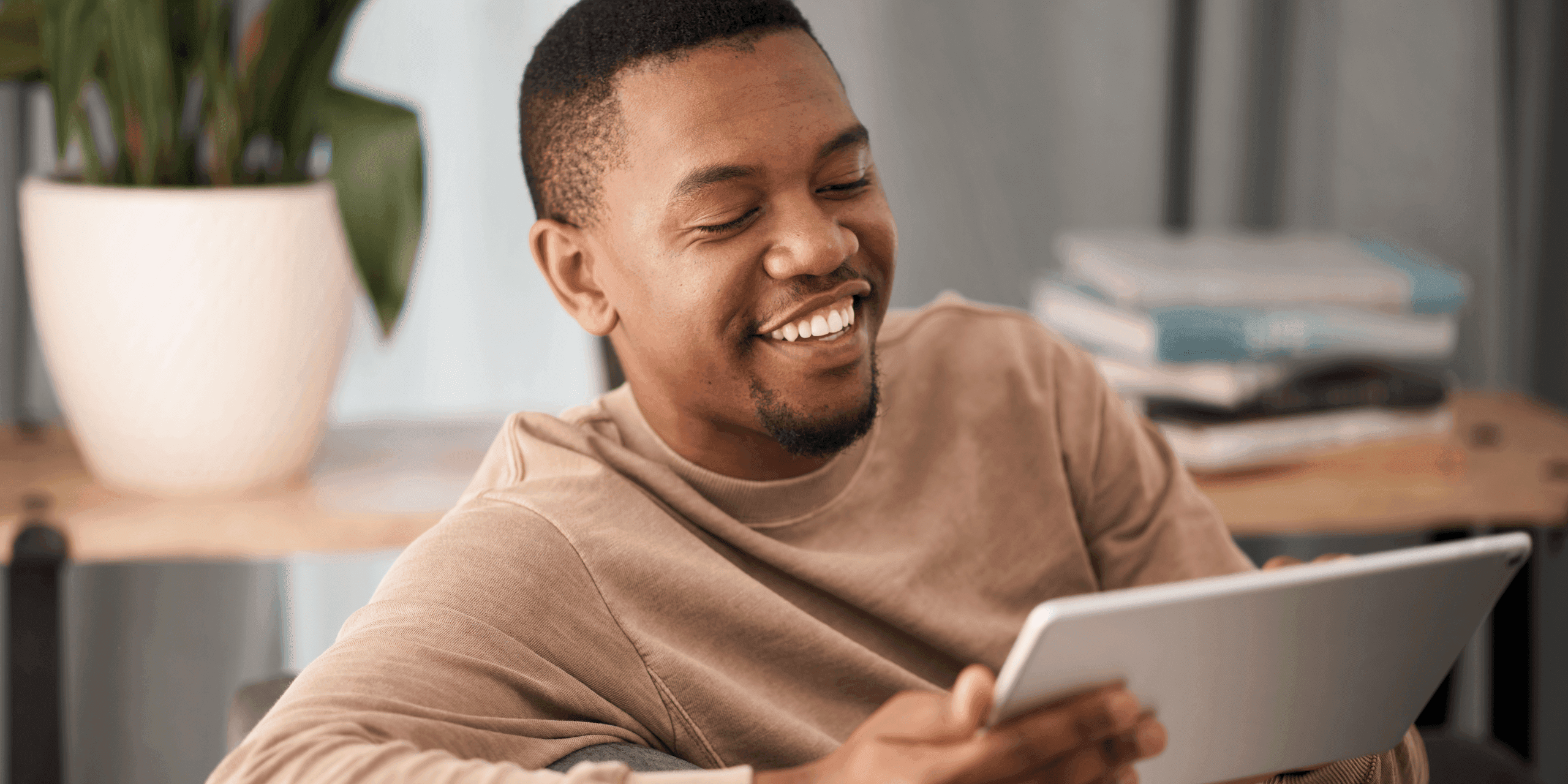 Man looking at tablet learning about website design for medical practices.
