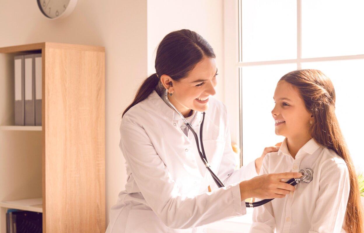 Physician using stethoscope and using clinic equipment on patient