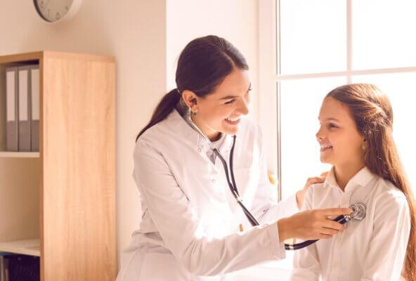 Physician using stethoscope and using clinic equipment on patient