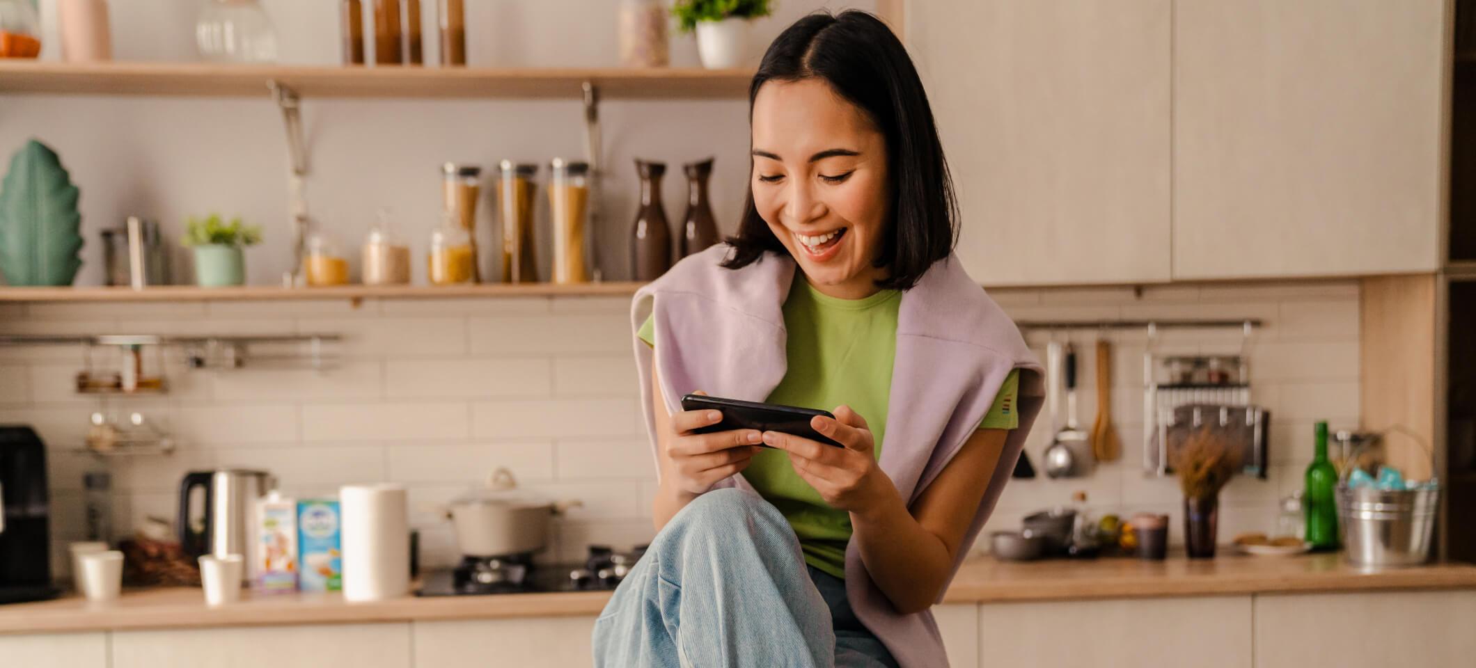 Smiling person looks at phone making a Google appointment with a healthcare provider