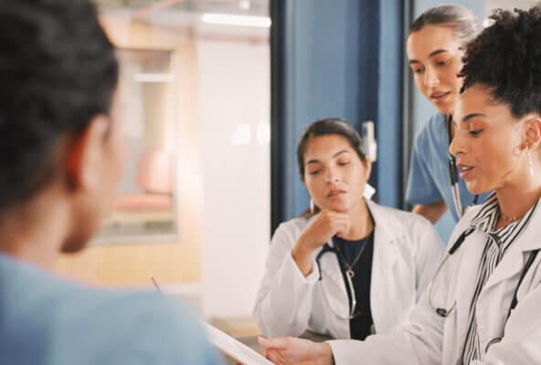 Physician and medical practice staff members discuss how to write an appointment cancellation letter from doctor to patient