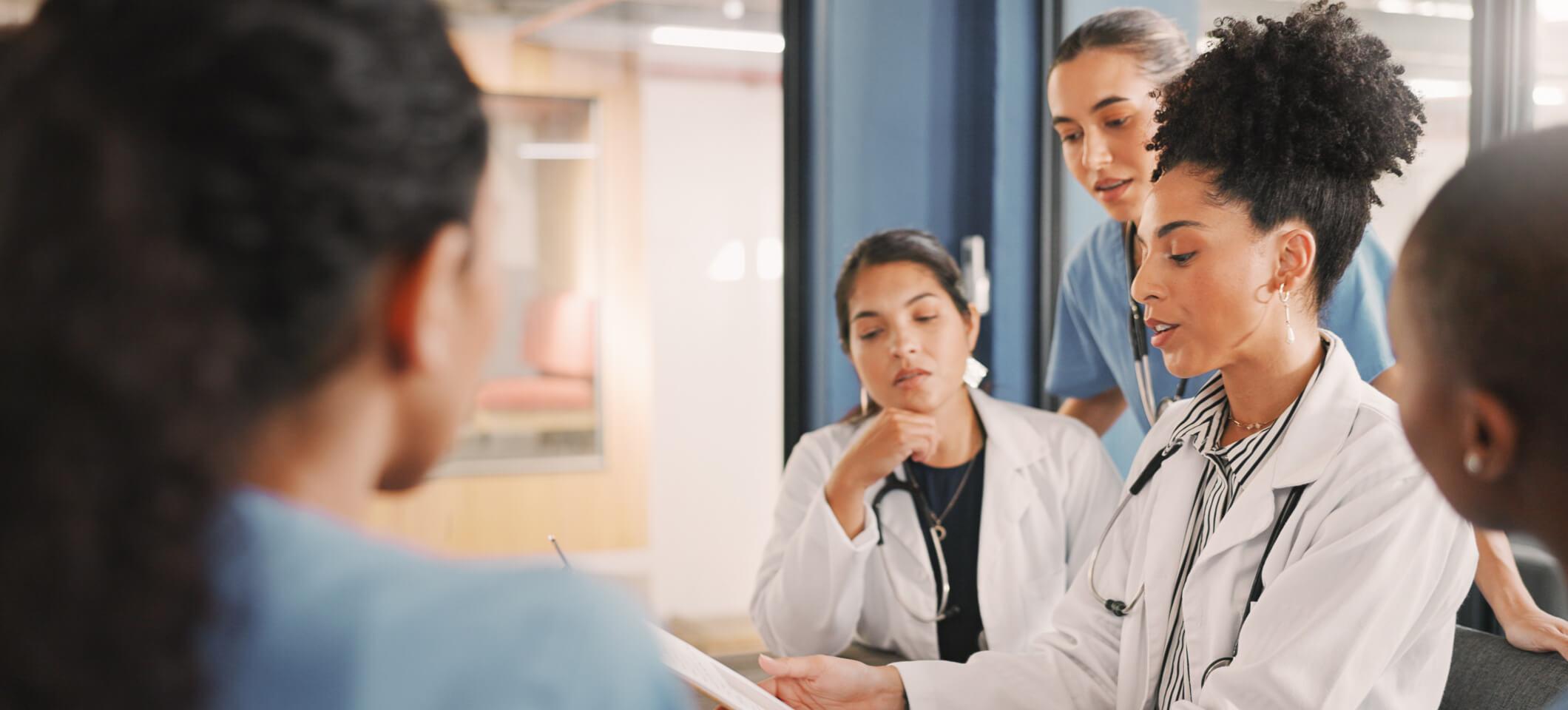 Physician and medical practice staff members discuss how to write an appointment cancellation letter from doctor to patient