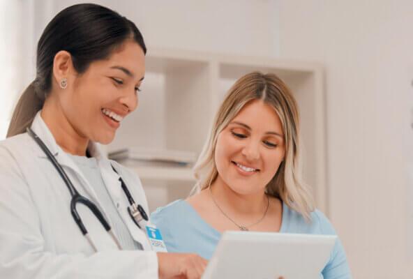 Physician shows patient survey on tablet to measure patient engagement