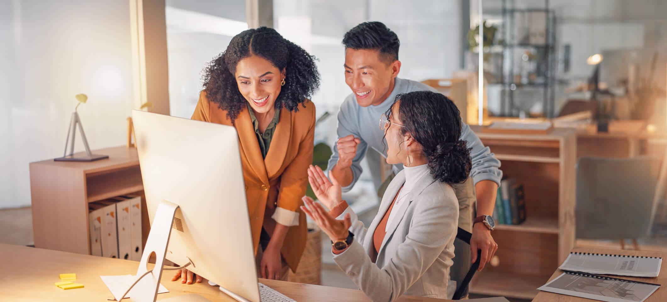 3 colleagues look at computer and celebrate as they get new medical billing business