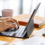 Medical billing and coding manager works on computer on E/M code 99214