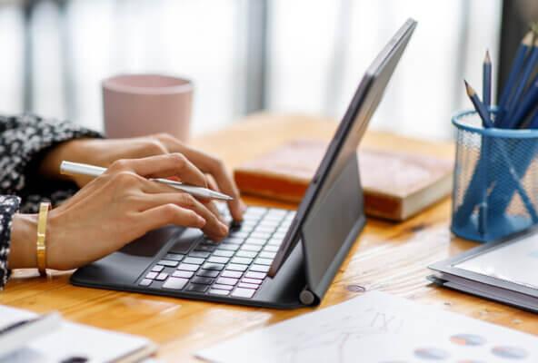 Medical billing and coding manager works on computer on E/M code 99214