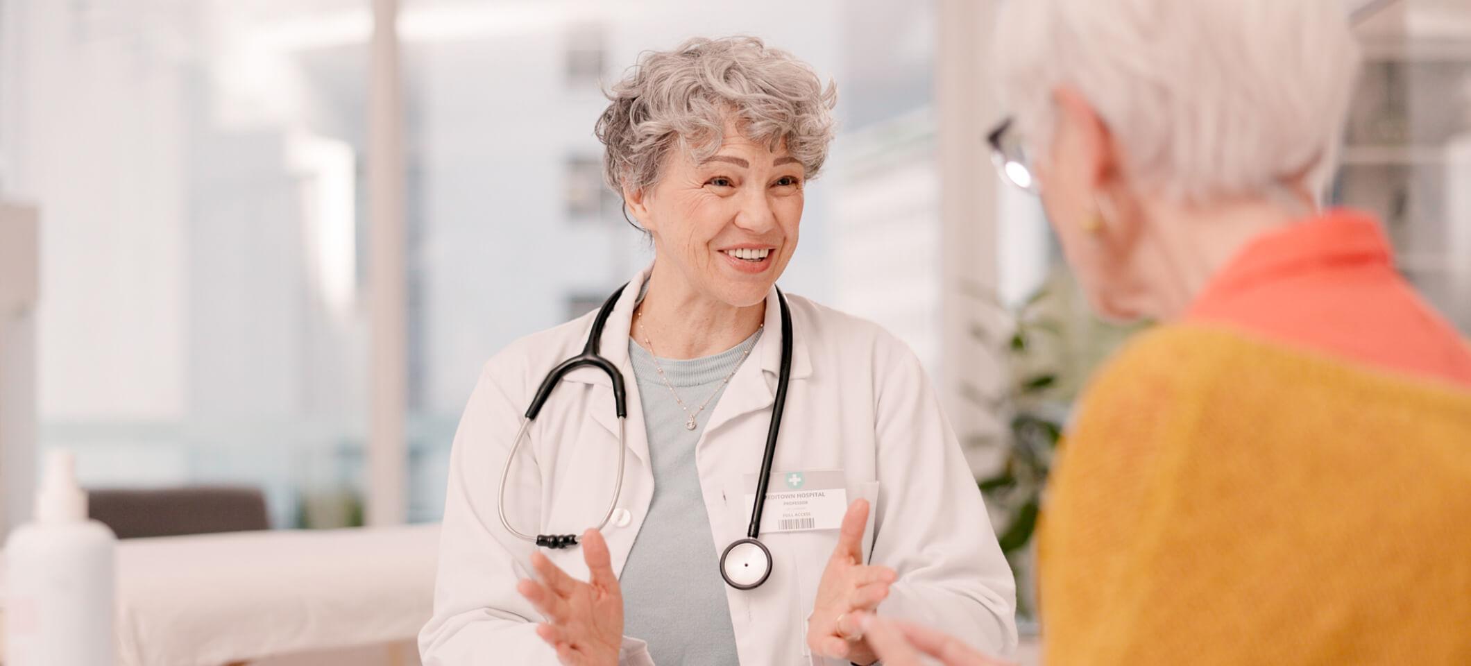 Physician talks with patient as part of February healthcare marketing ideas
