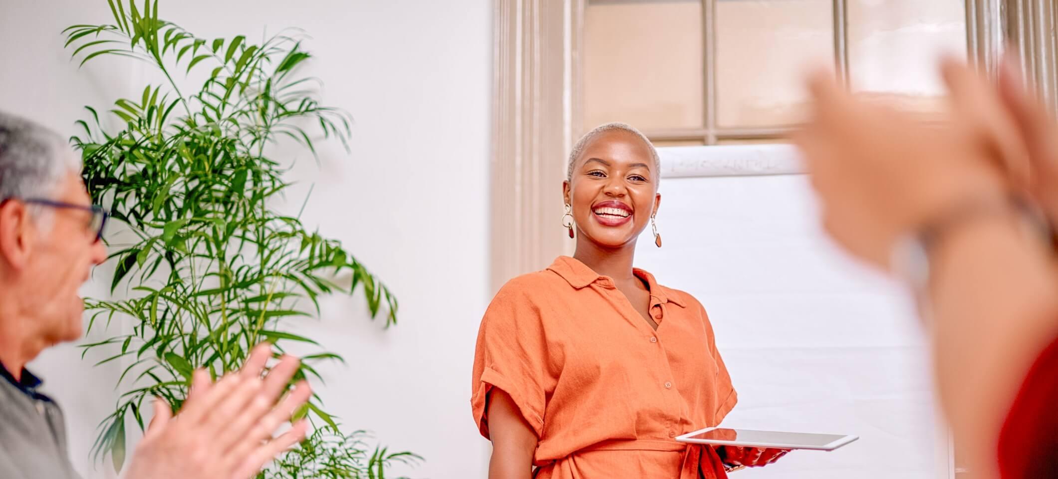 woman smiling and attending one of the 2025 healthcare conferences