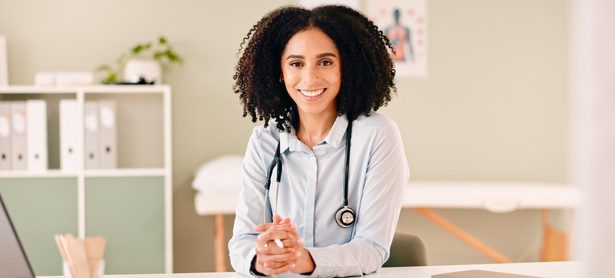 Physician smiles after reading about HIPAA cybersecurity resources