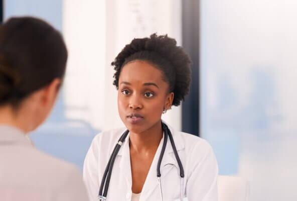 physician speaking with patient preparing for possible medicaid cuts