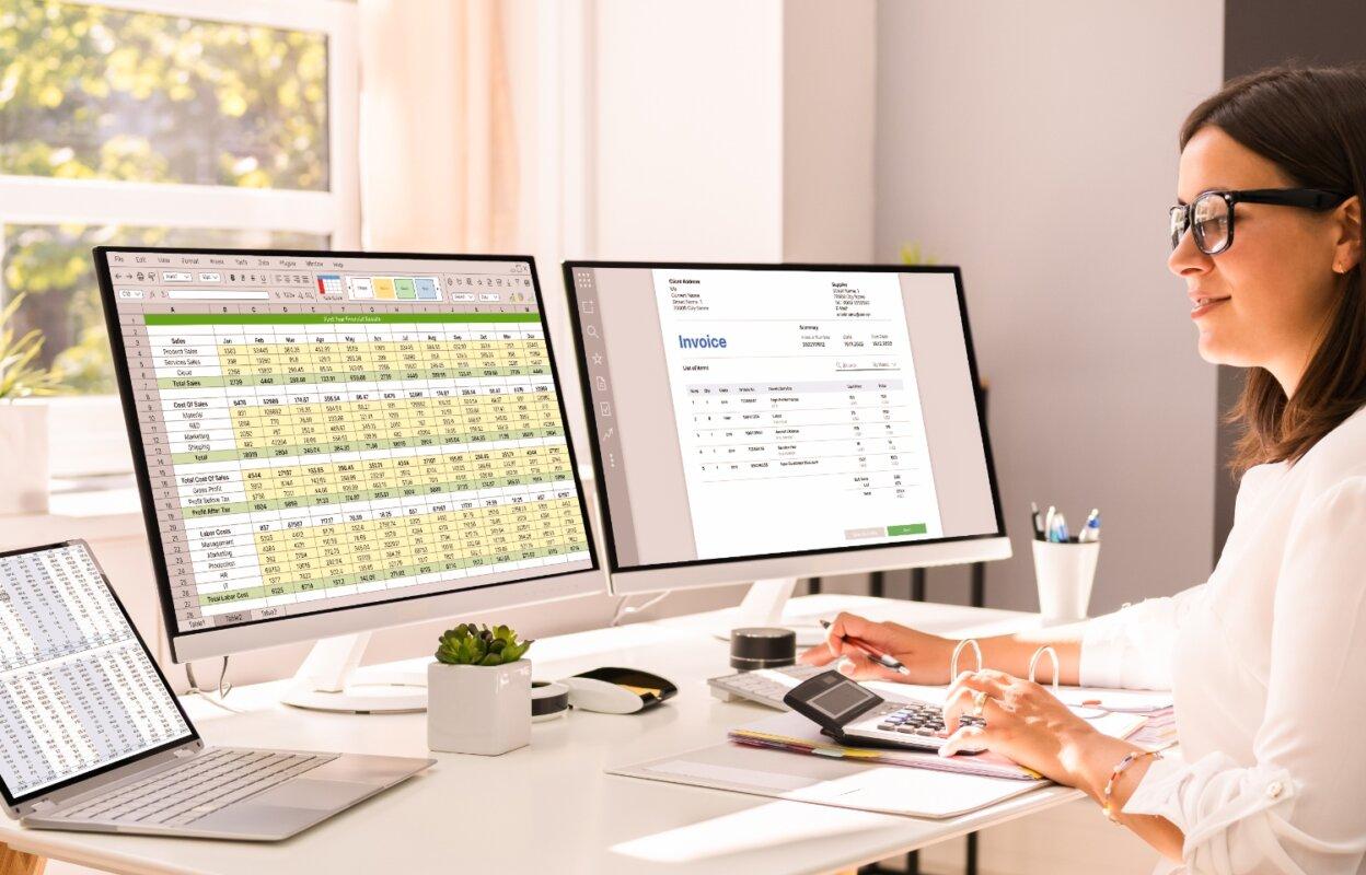 Person uses calculator after reading June 2025 revenue cycle management healthcare news