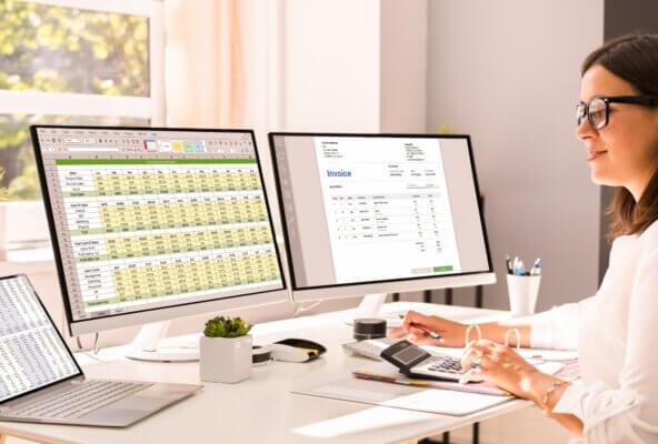 Person uses calculator after reading June 2025 revenue cycle management healthcare news