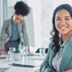 Biller smiles in office after applying medical billing automation strategies
