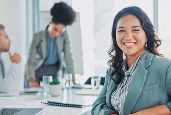 Biller smiles in office after applying medical billing automation strategies