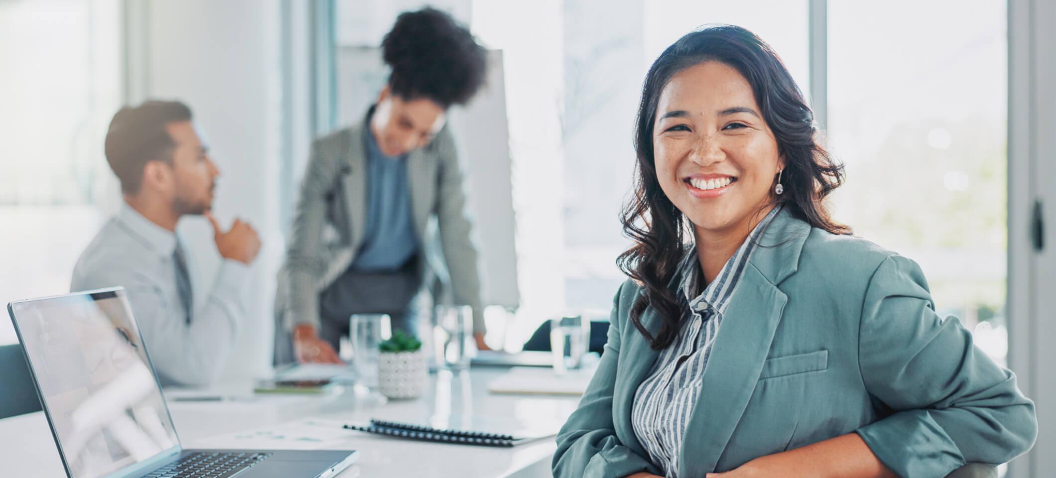 Biller smiles in office after applying medical billing automation strategies