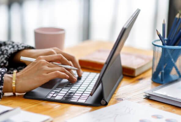 Person typing on keyboard looking up medical billing software cost