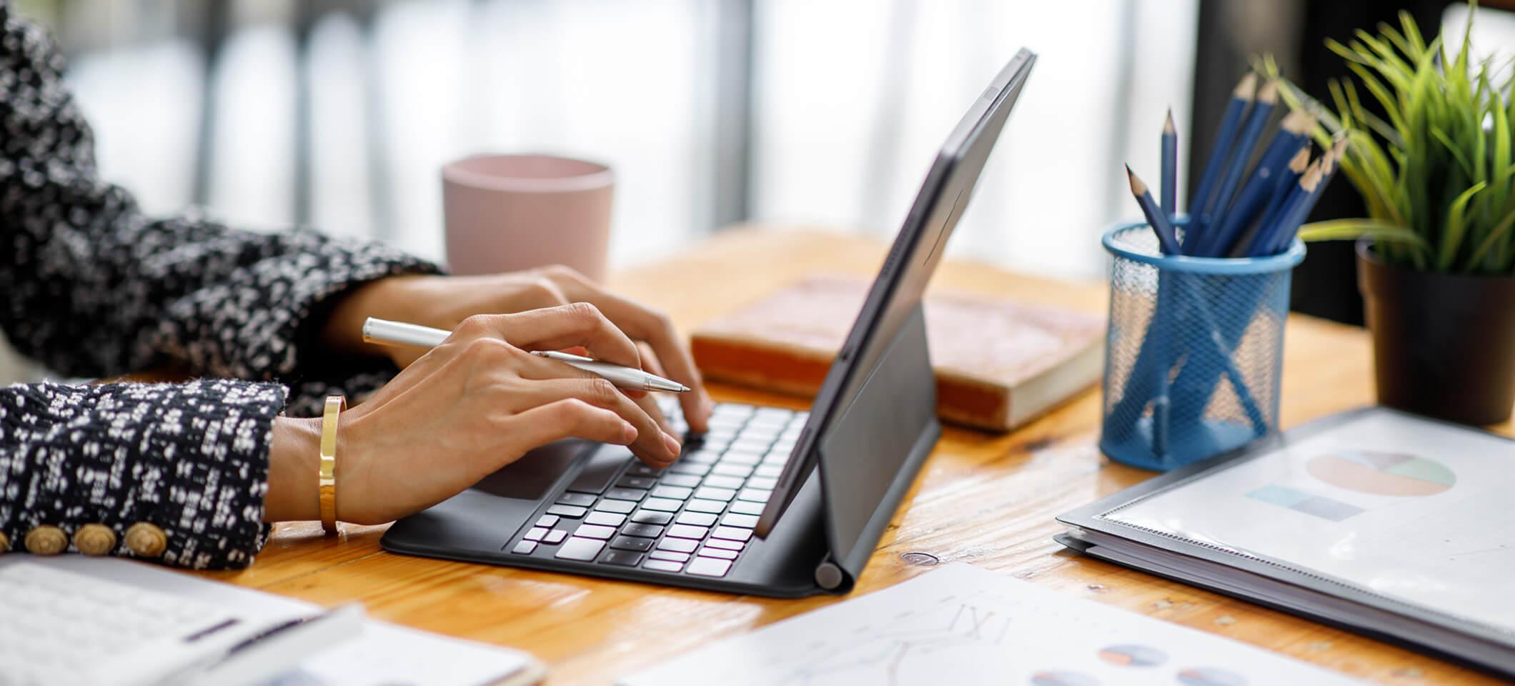 Person typing on keyboard looking up medical billing software cost