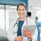 Doctor smiles holding tablet after reading 2026 ICD-10-CM code changes