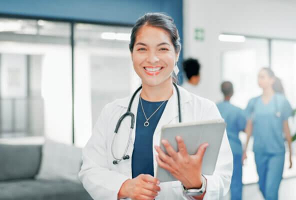 Doctor smiles holding tablet after reading 2026 ICD-10-CM code changes