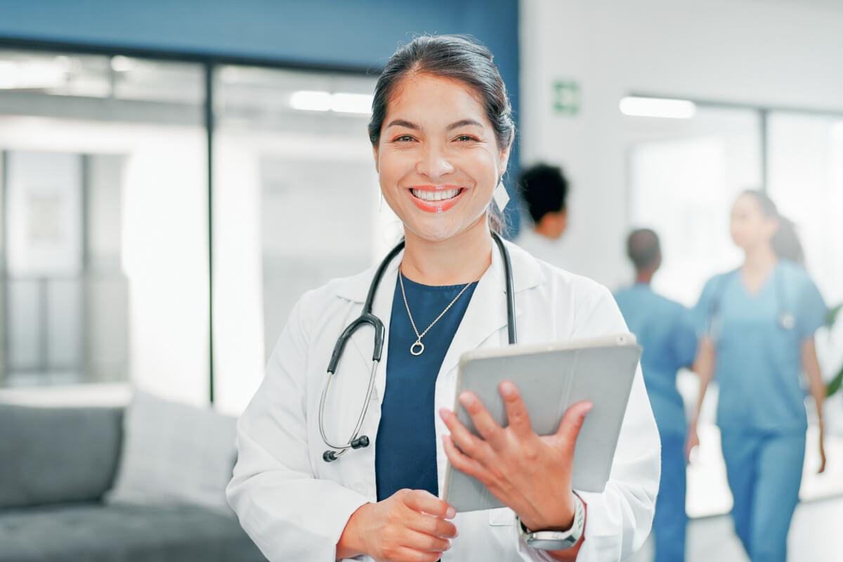 Doctor smiles holding tablet after reading 2026 ICD-10-CM code changes