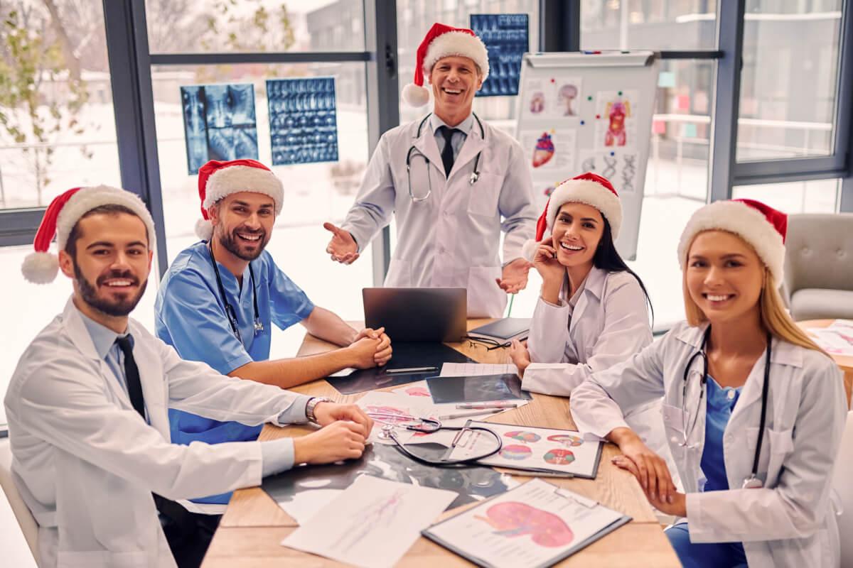 Group of smiling independent medical practice doctors discussing December 2025 healthcare observances