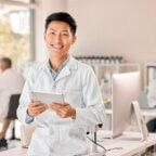A provider who optimized their EHR with AI, holding a tablet.