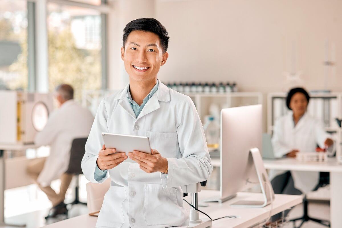 A provider who optimized their EHR with AI, holding a tablet.