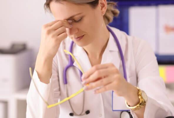 female physician experiencing burnout