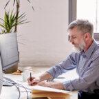 Man sending collections letter to patient on computer