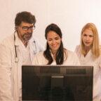 This is an image of 3 people in a medical practice looking at a computer. This is meant to show happiness as a result of streamlining a practice’s workflow.