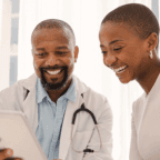 doctors reviewing new patient growth charts on a tablet