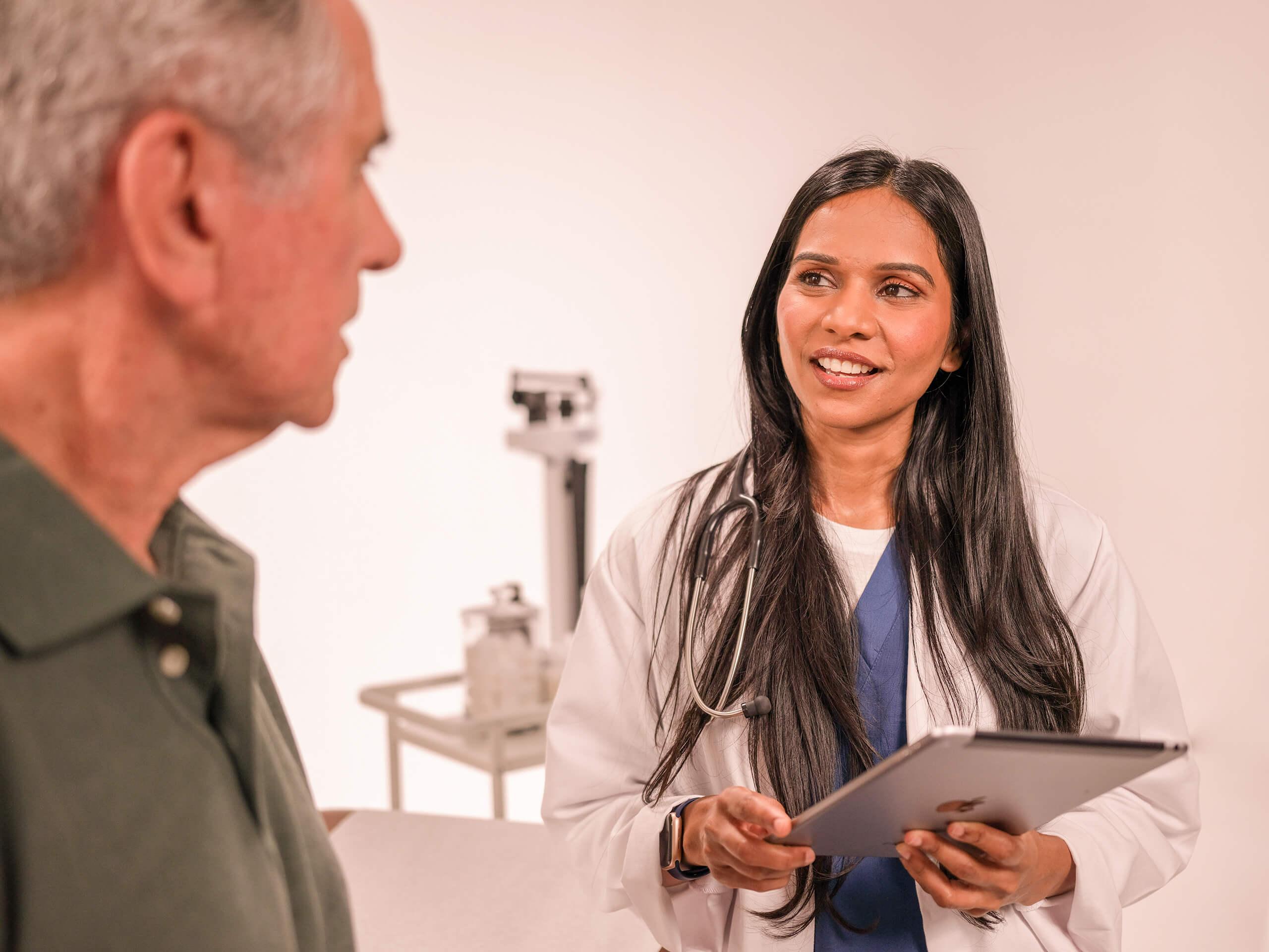 Photo of physician and patient representing private equity medical practice