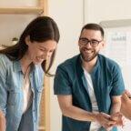 medical front office staff smiling and collaborating