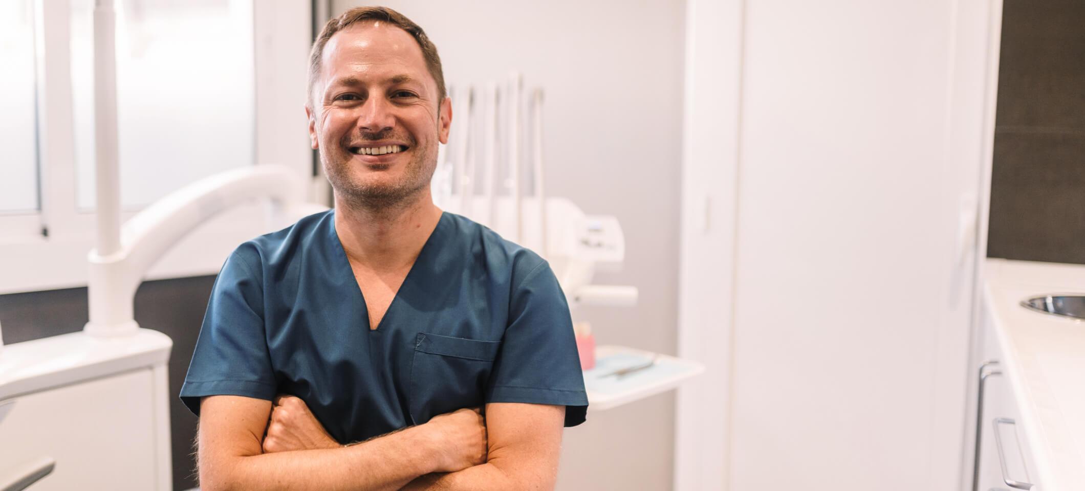 Smiling dentist poses for photo for his dental social media
