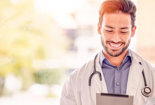 Physician looking at tablet learning about Google My Business for doctors
