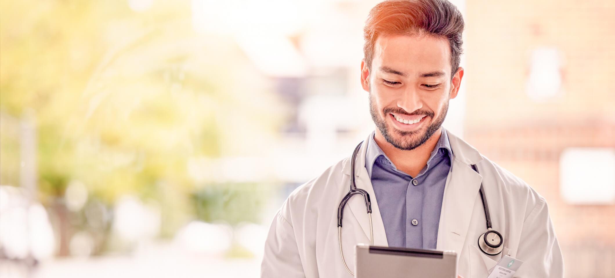Physician looking at tablet learning about Google My Business for doctors