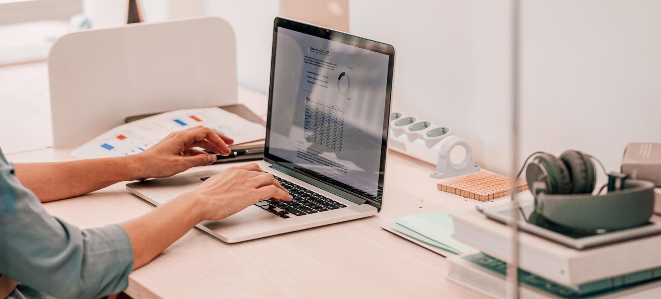 Medical practice manager works on healthcare conversion rate optimization on laptop computer