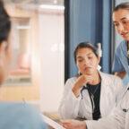 Physician and medical practice staff members discuss how to write an appointment cancellation letter from doctor to patient