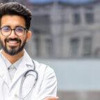 Doctor smiles at camera after reading about CY 2025 Medicare Physician Fee Schedule Final Rule