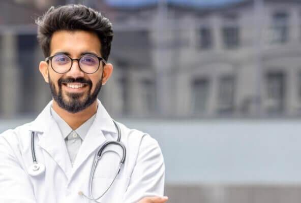 Doctor smiles at camera after reading about CY 2025 Medicare Physician Fee Schedule Final Rule