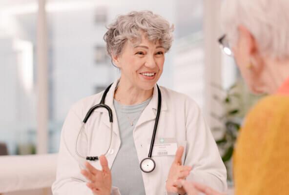 Physician talks with patient as part of February healthcare marketing ideas
