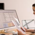 Physician looks at billing paperwork considering how to choose the best medical billing software