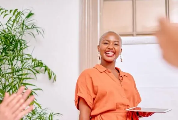 woman smiling and attending one of the 2025 healthcare conferences
