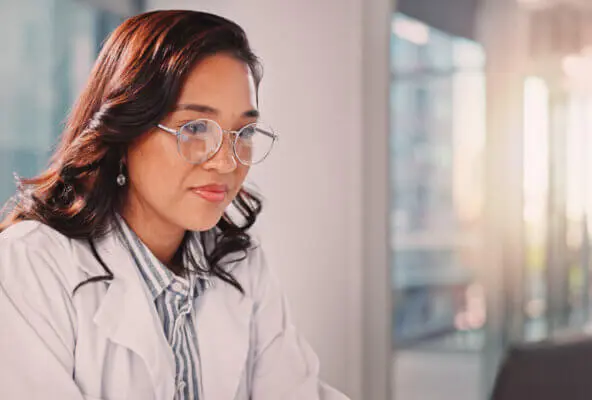 Physicians reads March revenue cycle management healthcare news on computer