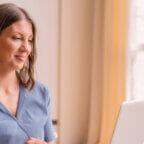 Physician reads on laptop about how AI eases cognitive load for doctors