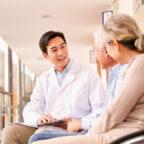 Doctor talking with patients exhibits how to increase revenue with patient experience software