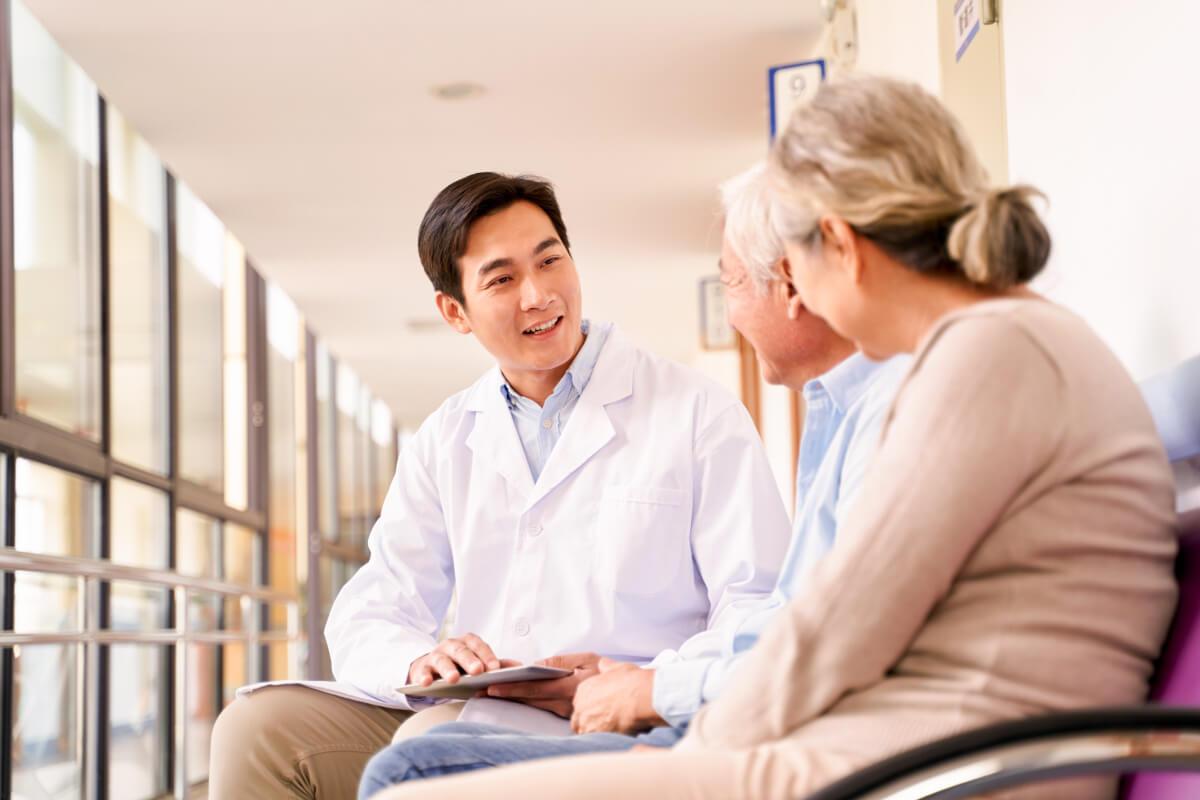 Doctor talking with patients exhibits how to increase revenue with patient experience software