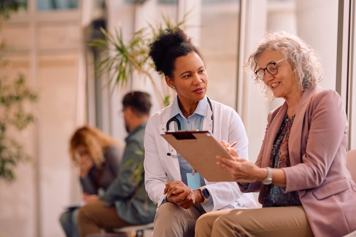 A doctor supporting patient health insurance financial literacy.
